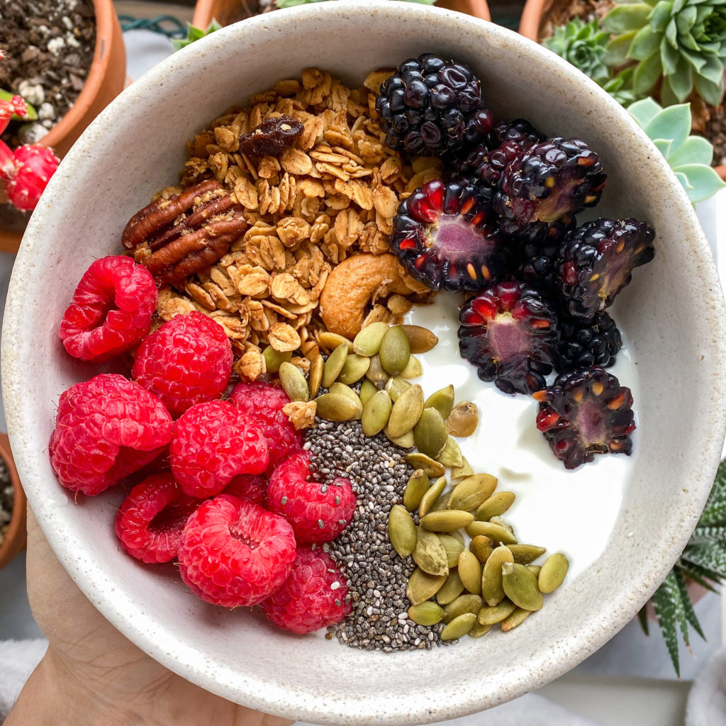 Bowl with yogurt, granola, berries, pumpkin seeds and chia seeds