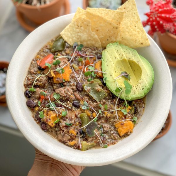 Bowl of chili with avocado and chips